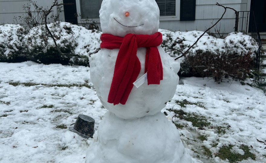 A snowman with a red scarf