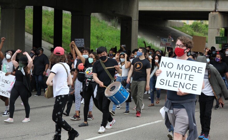 demonstrators marching down washtenaw avenue with signs