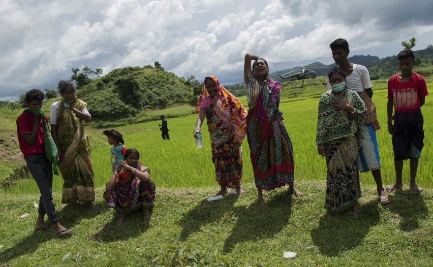 Hindu residents react in grief when shown the bodies of their dead family members in Maungdaw township last September, shortly after Myanmar's military announced that it had discovered a mass grave in Rakhine state.