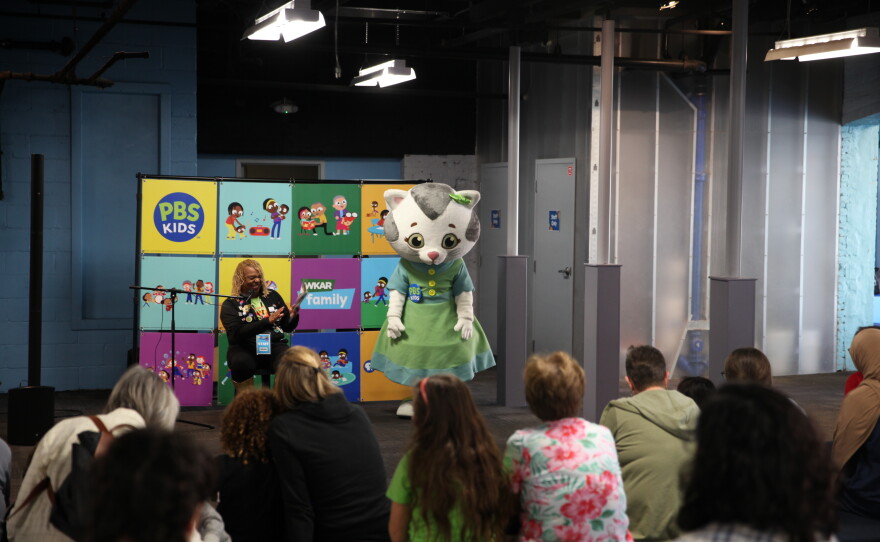 Robin Pizzo, WKAR director of education, reads to children and their families with Katerina Kittycat during StoryTime with Mrs. Pizzo.