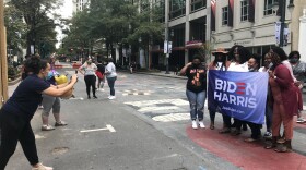 Biden supporters take photos at the Black Lives Matter mural in uptown Charlotte Saturday after learning that Joe Biden had been declared president-elect of the United States.