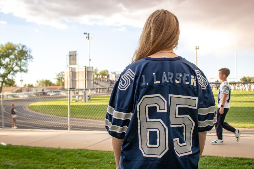 Junior Eliza Larsen wears her dad’s Millard High football jersey to the homecoming game, Sept. 26, 2025.