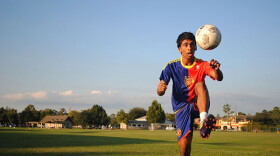 Samuel John uses his legs to juggle a soccer ball