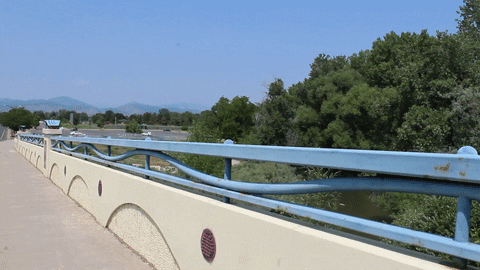 A bridge over the Big Thompson River overlooking nature.