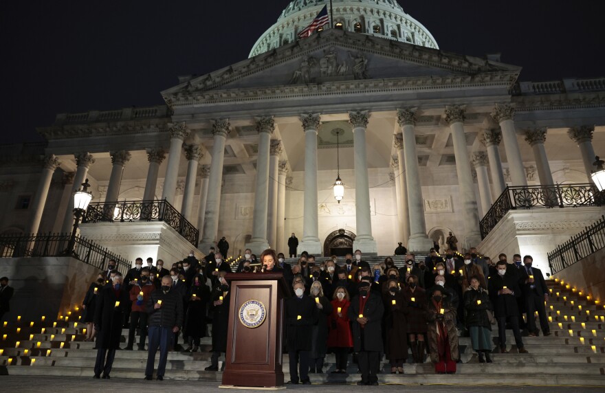 House Speaker Nancy Pelosi, D-Calif., pauses for a moment of silence alongside fellow lawmakers and congressional staff members during a vigil Thursday evening to commemorate the anniversary of the Jan. 6 attack on the U.S. Capitol.