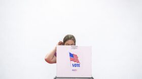A woman scratches her head as she casts her ballot during the Maryland state primary election at a polling station in Annapolis, Maryland.