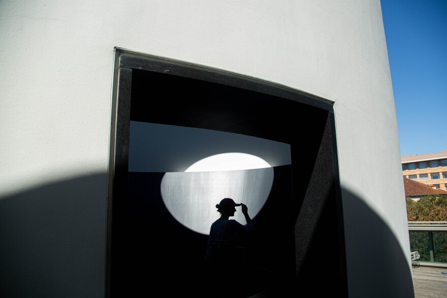 A silhoutted shadow of a visitor to the The Color Inside, A Skyspace installation by artist James Turrell located at the Student Activity Center at The University of Texas at Austin on Feb. 11, 2022. Patricia Lim/KUT