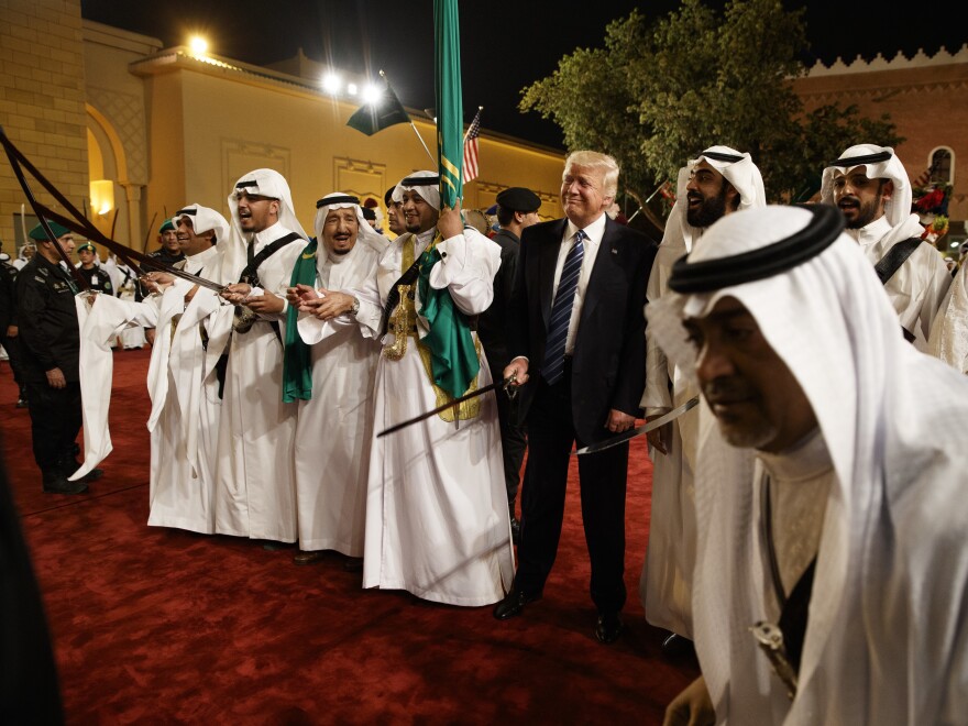 President Trump holds a sword and sways with traditional dancers during a welcome ceremony at Murabba Palace on Saturday in Riyadh.