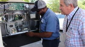 Auditor Keith and Inspector Joe Harris check a pump for skimmers.