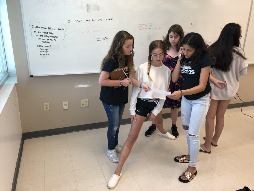 Participants in a songwriting class work together to write lyrics and a melody. They start a new school year at Marjory Stoneman Douglas High School this week. 