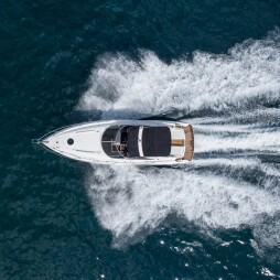 Aerial top down view of speed motor boat on open blue sea