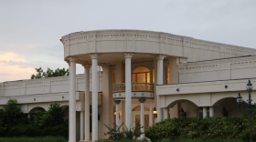 Lights shine inside the white mansion on Buffalo Gap Road during the early morning.