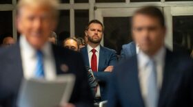 U.S. Sen. JD Vance (R-OH) looks on as former President Donald Trump speaks to the media during Trump's trial for allegedly covering up hush money payments at Manhattan Criminal Court in New York City.