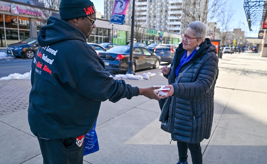 Sharee Clark hands out a Valentine gift on Public Square in Wilkes-Barre. Clark started the True Love Movement when she was feeling depressed in college.