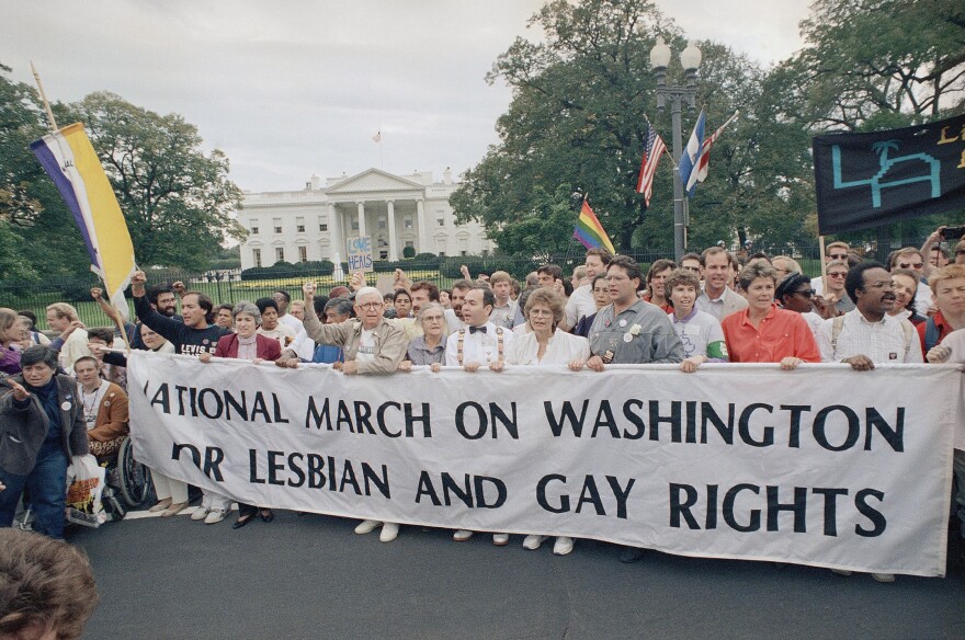 Participants of the National March on Washington for Lesbian and Gay Rights carry a banner as they parade in front of the White House, Sunday, Oct. 11, 1987, Washington, D.C. U.S. Park Police have estimated that some 50,000 are participating in the march. (AP Photo)