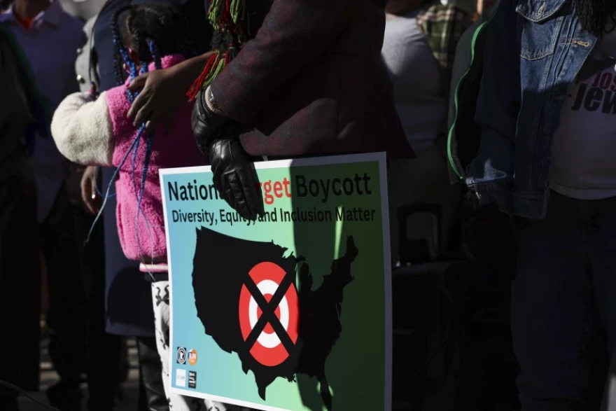 A community member holds a sign calling for a national boycott of Target, during a January news conference outside Target’s headquarters.