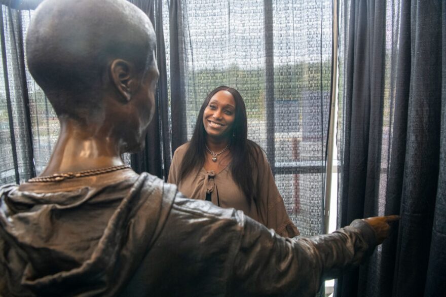 Shalisa Hayes looks at a sculpture of her son Billy Ray Shirley III.