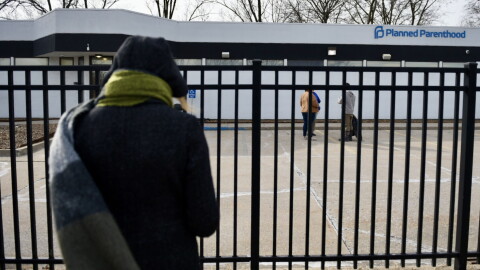 An activist with 40 Days for Life prays as she stands outside the Columbia Planned Parenthood clinic on Monday, March 3, 2025 shortly after the clinics restarted procedural abortions under the state's reproductive rights amendment (Anna Spoerre/Missouri Independent).