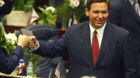 FILE - In this Tuesday, March 1, 2021 file photo, Florida Gov. Ron DeSantis fist bumps with legislators as he enters the House of Representatives prior to his State of the State address at the Capitol in Tallahassee, Fla. Democrats hope to make deeper strides in changing their fortunes in a state that has become friendlier place for Republicans. The state's only Democrat in statewide office, Agriculture Commissioner Nikki Fried is contemplating a challenge to Republican Gov. DeSantis.  (AP Photo/Phil Sears, File)