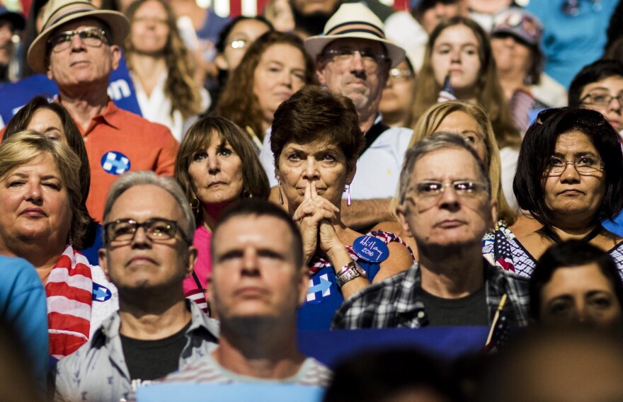 Audience members watch as Democratic presidential nominee Hillary Clinton and her running mate, Sen. Tim Kaine, speak at a rally in Miami.