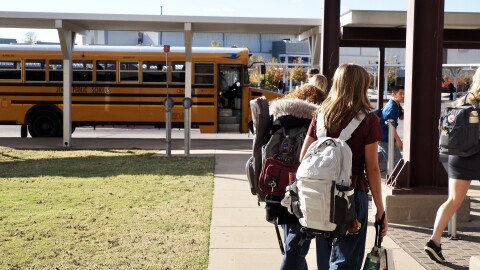 Jenks High School students walk out of the Jenks Public Schools Math and Science Center on Nov. 13. All public schools in the state must enforce a cellphone ban this year.