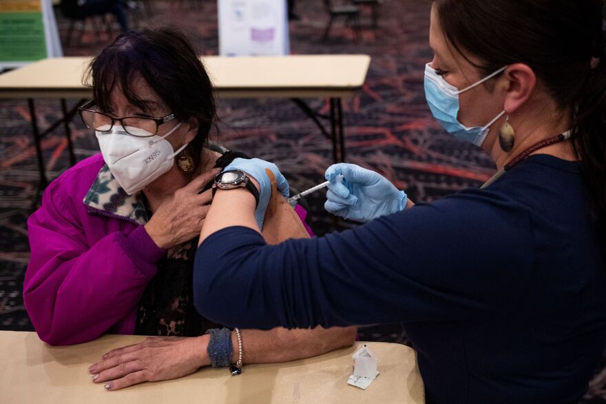 Tribal health nurse Malia Kipp delivers a second dose of the Pfizer-BioNTech vaccine to Marlene Reaves during a Confederated Salish and Kootenai vaccination clinic at the KwaTaqNuk Resort in Polson, Montana, on March 30, 2021. After her vaccination, Reaves said she looks forward to traveling to a hospital and visiting her grandson who was recently diagnosed with cancer.