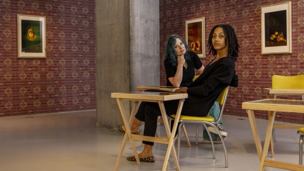 Glenna Jennings and Jalisa Robinson sit within their exhibition at Cincinnati Contemporary Art Center 