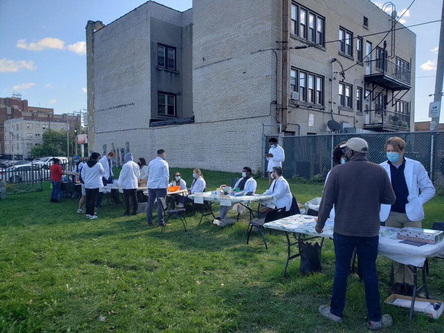 Students at the Medical College of Wisconsin host an outdoor health clinic during the coronavirus pandemic in 2021. Now, there's another outbreak in the state for which a vaccine already exists.