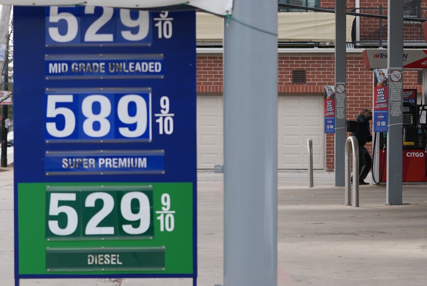 Gas prices are displayed as a man checks gas prices before he fills up his vehicle's gas tank at a gas station in Chicago, Wednesday, March 25, 2026. (AP Photo/Nam Y. Huh)