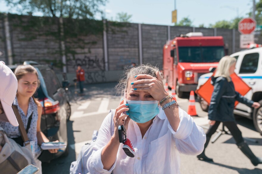 Martha Suarez (c) reacts outside a house where people who died in the flooding in Queens, New York on September 2.