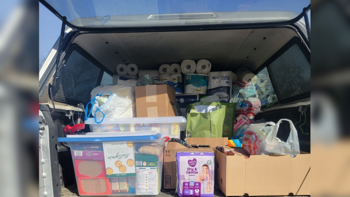 A truck is loaded with paper supplies like diapers and toilet paper as well as non-perishable food items to deliver to those in need.