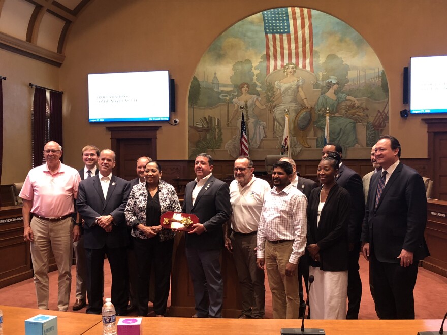 Chief Craig Harper of the Peoria Tribe of Indians of Oklahoma holds a key to the City of Peoria as he poses with Mayor Rita Ali and members of the City Council.