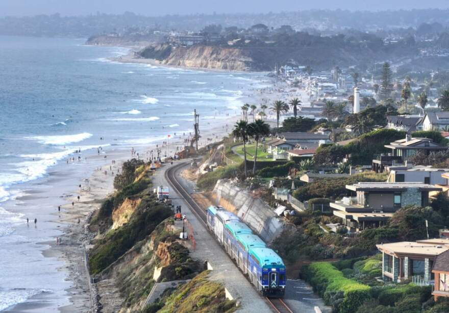 An aerial view of a Coaster commuter train passing along eroding cliffs at the Pacific Ocean coastline on August 16, 2024 in Del Mar, California. (Mario Tama/Getty Images)