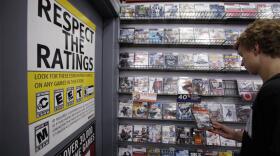 A shopped looks at video games at GameStop in Palo Alto, Calif. (Paul Sakuma/AP)