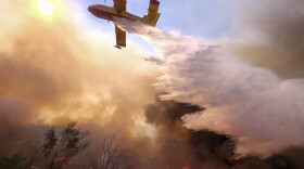 An air tanker drops water on a fire along the Ronald Reagan Freeway in Simi Valley, Calif., Monday, Nov. 12, 2018. (Ringo H.W. Chiu/AP)