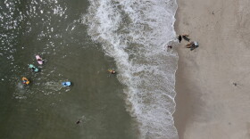 Beachgoers enjoy a hot day along the Atlantic Ocean, Saturday, July 18, 2020, in Rehoboth Beach, Delaware. (Julio Cortez/AP)