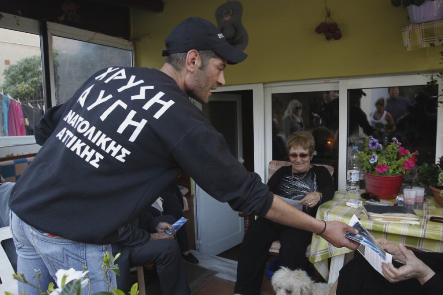 Reeling from a vicious financial crisis that has cost them pensions and jobs, Greeks have been turning away in droves from the mainstream politicians they feel have let them down. Here, a member of the far-right Golden Dawn party hands out election pamphlets in Artemis on April 26.