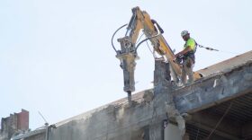 The Kansas Legislature passed a bill raising the ceiling for no-bid county construction projects and rejected a companion proposal repealing construction worker protections. A construction worker appears on Aug. 17, 2023, demolishing the former Docking State Office Building in downtown Topeka, Kansas.