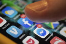 FILE - A smartphone displays the apps for Facebook and Messenger, both owned by Meta. (AP Photo/Jenny Kane, File)
