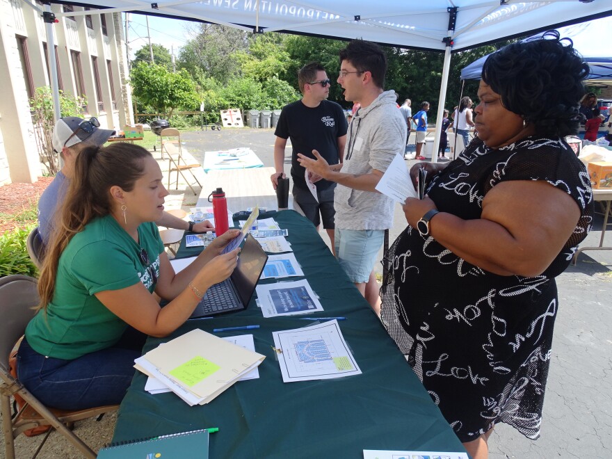 Fatima Robinson (right) signed up for the next phase of the sewer assessment. Alexis Laverdiere (seated ) with Greenprint Partners helped facilitate the resident-led project.