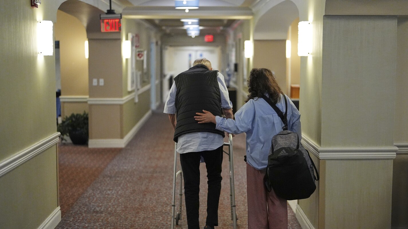 People walk inside the assisted living facility at the Toby and Leon Cooperman Sinai Residences, July 4, 2025, in Boca Raton, Fla. (AP Photo/Rebecca Blackwell)