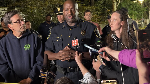 Seattle Police Assistant Chief Tyrone Davis speaks at a press conference with Gov. Bob Ferguson, left, and Seattle Mayor Katie Wilson, right, following a shooting at Seattle Center Sunday, July 26, 2026.