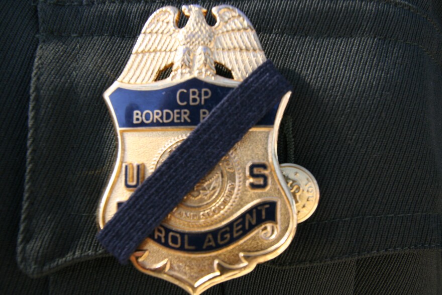 A Border Patrol agent wears a black band over his badge to honor slain Agent Brian Terry.