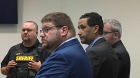 Luciano Frattolin is flanked by his lawyers as jurors announce their verdict