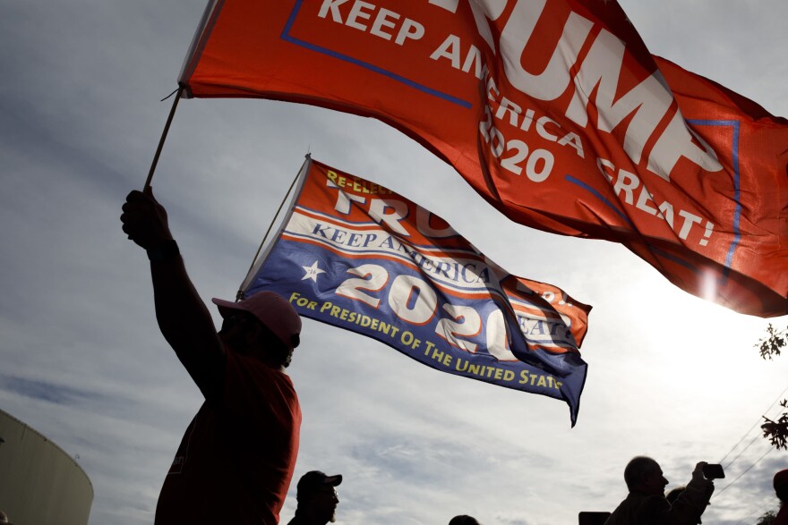 A supporter of President Trump waves flags outside of McKenzie Arena, where U.S. President Donald Trump is holding a rally in support of Republican Senate candidate Rep. Marsha Blackburn, Nov. 4, 2018 in Chattanooga, Tennessee. (Drew Angerer/Getty Images)