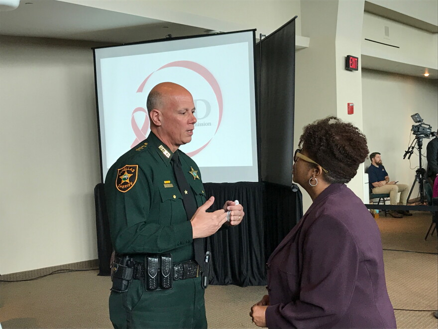 Pinellas County Sheriff Bob Gualtieri (left), the chair of the Public Safety Commission, speaks with Broward County administrator Bertha Henry on Thursday.   