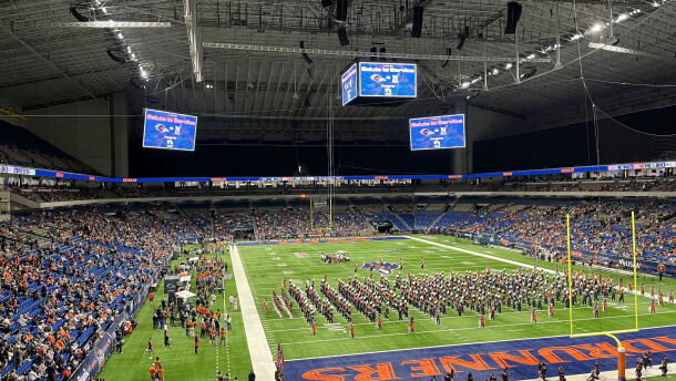 First responders treat an injured service member following a fall at the Alamodome Saturday.