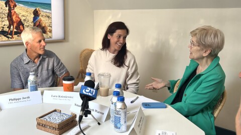 Sen. Elizabeth Warren, right, talks with Philippe Jordi, CEO of Island Housing Trust, left, and Lora Ksieniewicz, owner of Yoga on the Vine. They were part of a community roundtable Warren hosted at the Martha's Vineyard Chamber of Commerce in Vineyard Haven, about the difficult housing climate on the Vineyard. Aug. 14, 2026.