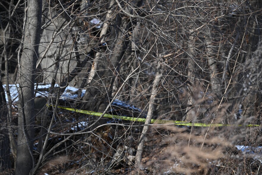 Police tape surrounds trees off Thayer Street in Wilkes-Barre Tuesday afternoon, Feb. 24, 2026, three days after a body was found nearby.