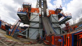 In this photo made with a fisheye lens, on Thursday, March 12, 2020, work continues at a Seneca Resources shale gas well drilling site in St. Mary's, Pa.
